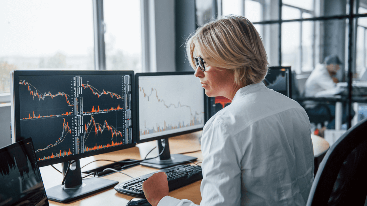 Stock Marketplace Solution Image - Woman check her stocks on her computer