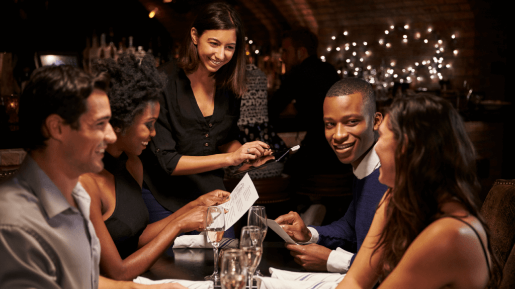 DISH Hospitality - Waitress taking order on tablet from group of people